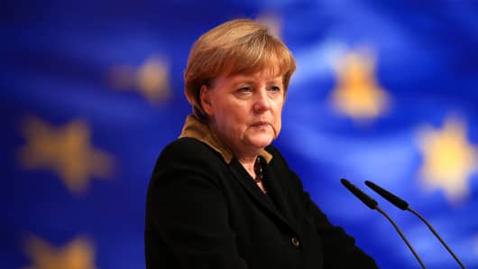 German Chancellor Angela Merkel, speaks in front of a flag of the European Union